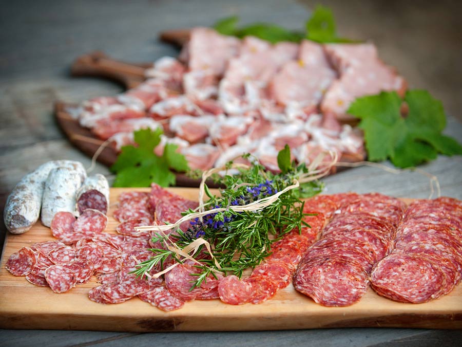 Sliced salami on a wooden board