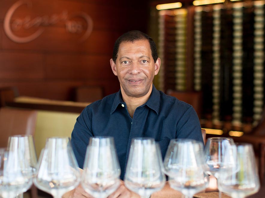 man sitting in front of wine glasses