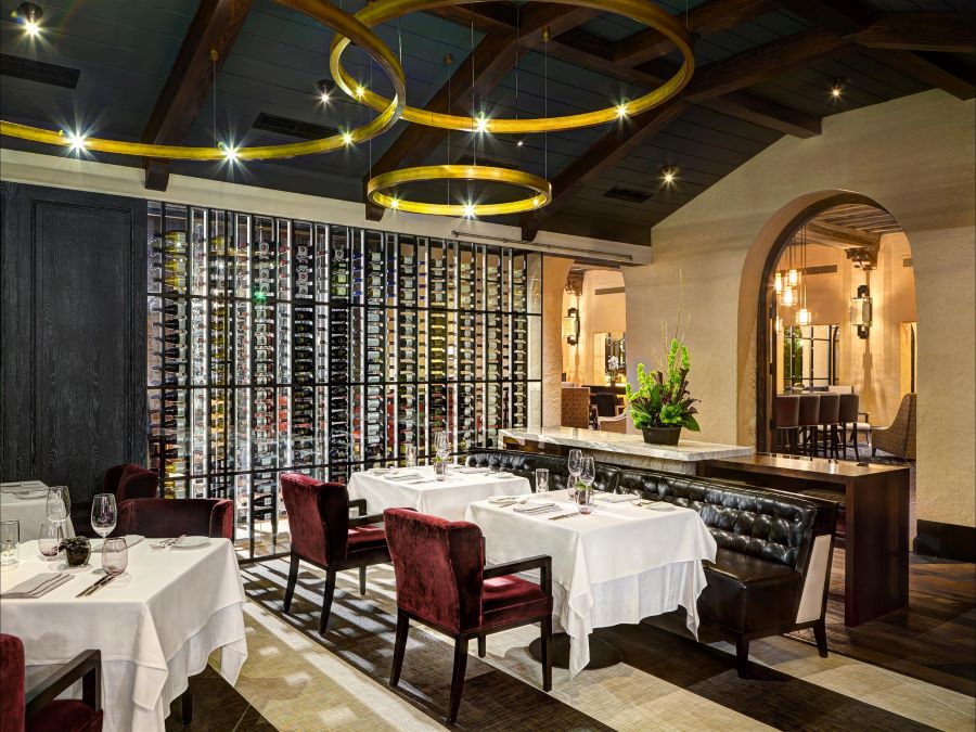 A modern dining room with tables in white tablecloths