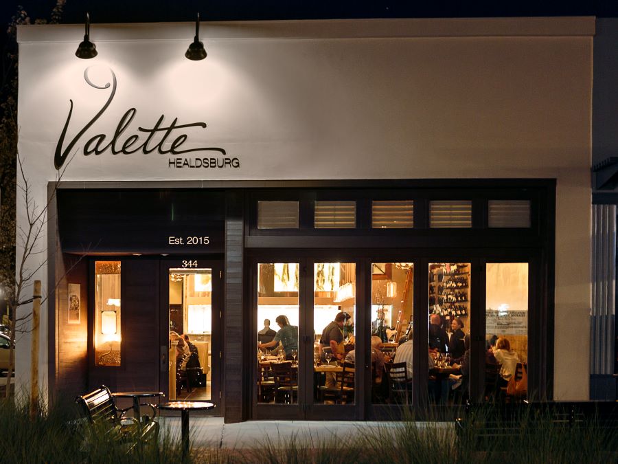 Exterior of Valette, a popular Healdsburg restaurant, at night.