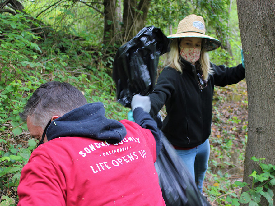 A photo of two volunteers cleaning litter at Steelhead Beach Regional Park