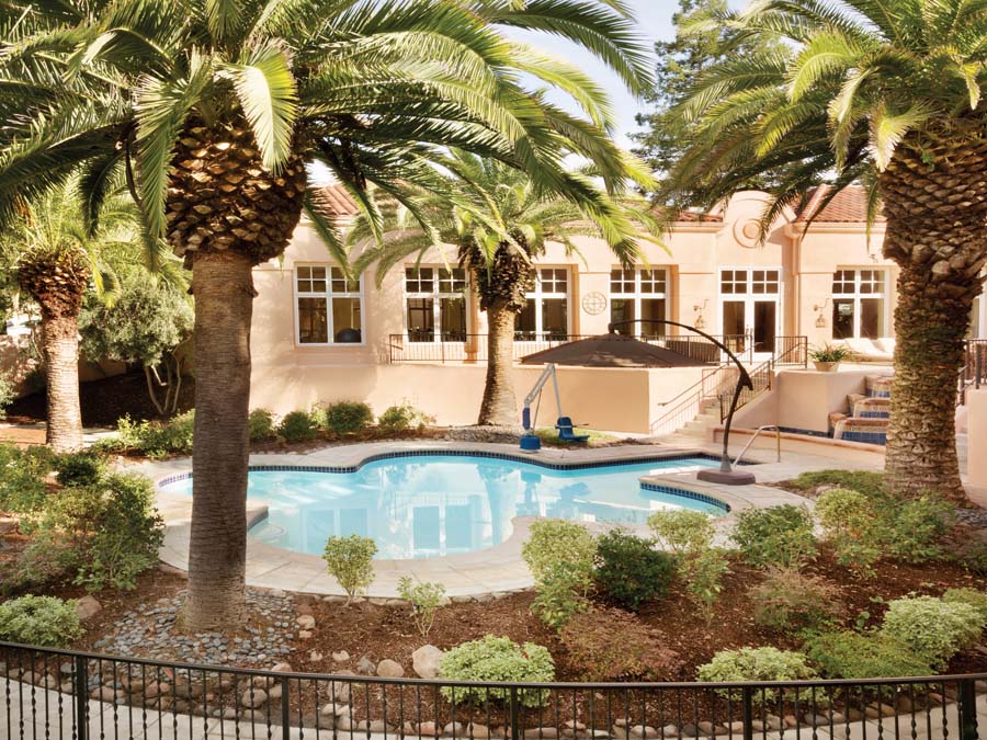 The luxurious pool is surrounded by palm trees at the Fairmont Sonoma Mission Inn & Spa