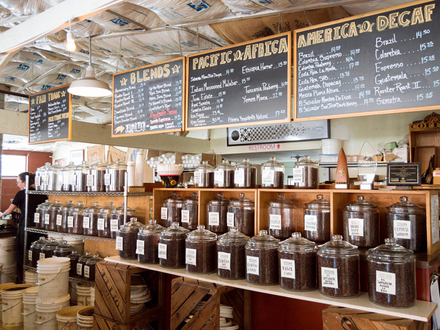 Beans stand in clear jars under a menu of the day's roasts at Petaluma Coffee & Tea Co. in Petaluma, Sonoma County, California