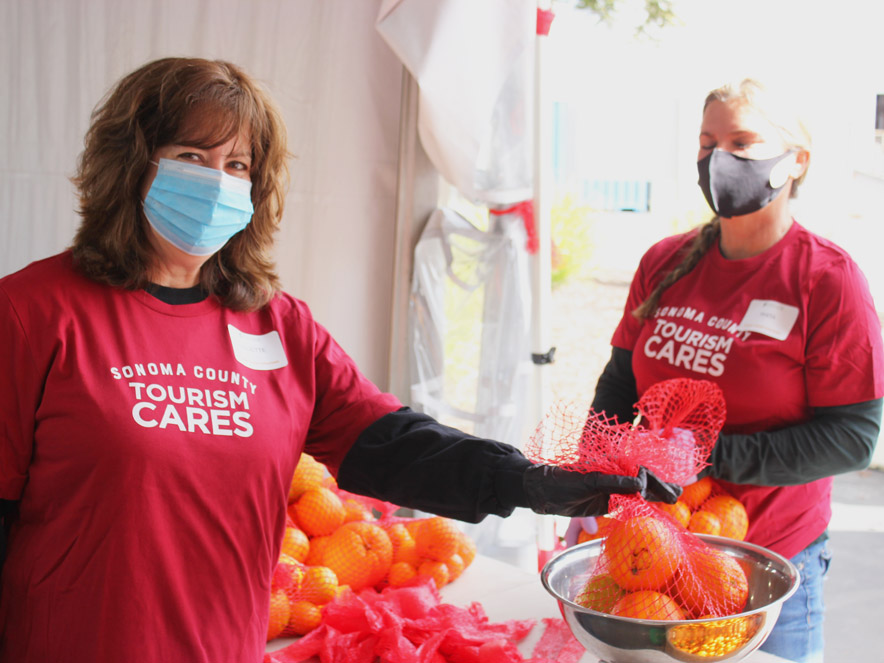 Two Tourism Cares volunteers at Redwood Empire Food Bank