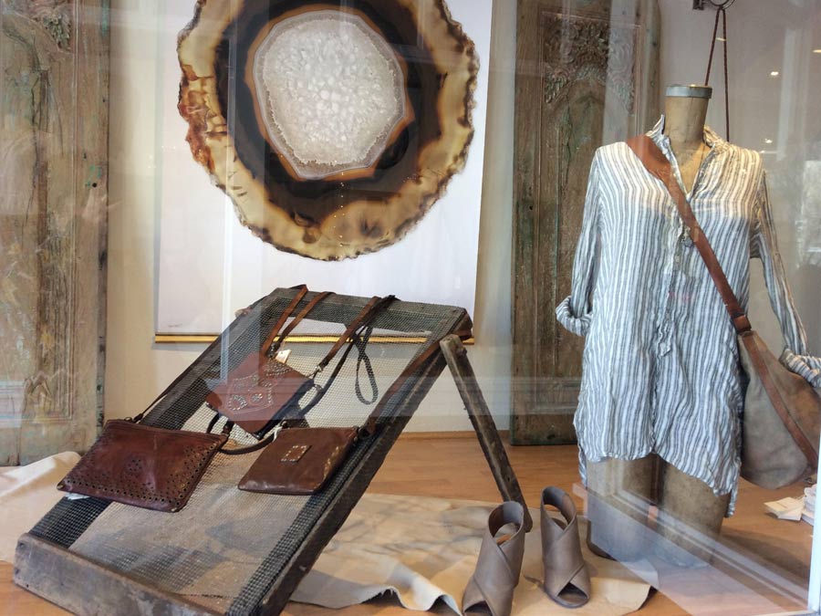 A store window shows off clothing and handbags