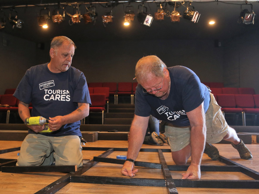 Two men working on a set at Left Edge Theatre.