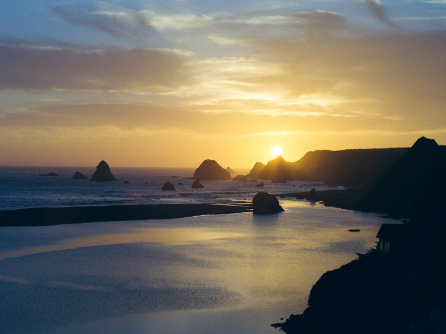 The sun sets where the river meets the sea at Jenner