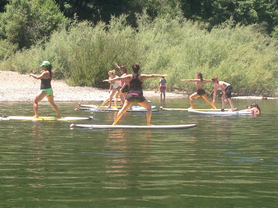 People do yoga on paddleboards in the Russian River in Sonoma County