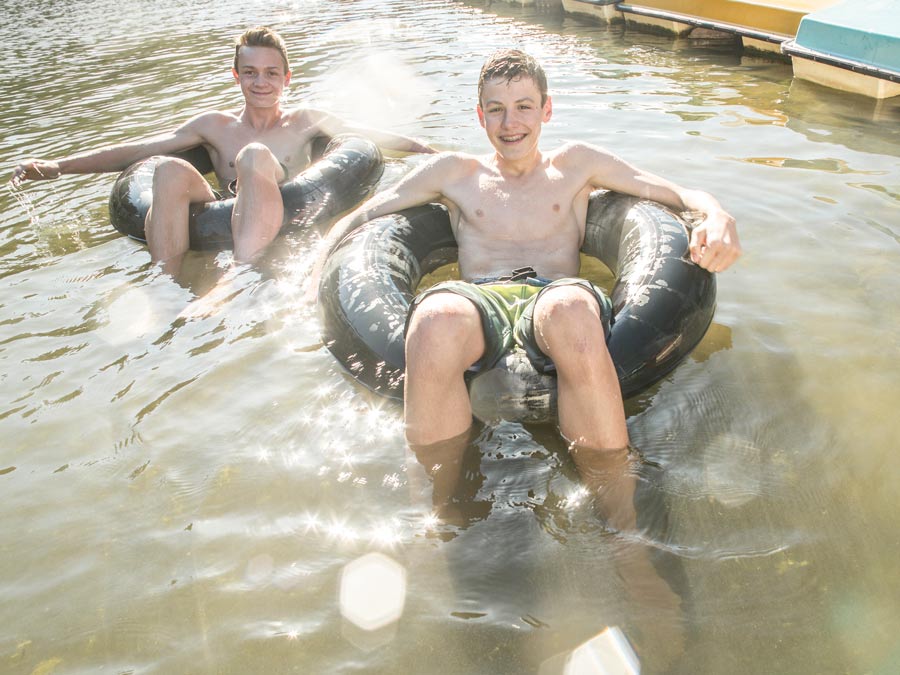 Two young men float in inner tubes in the Russian River at Johnson's Beach, Guerneville