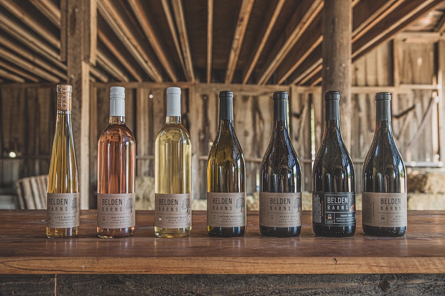 Wine bottles lined up on the bar inside the barn at Belden Barns