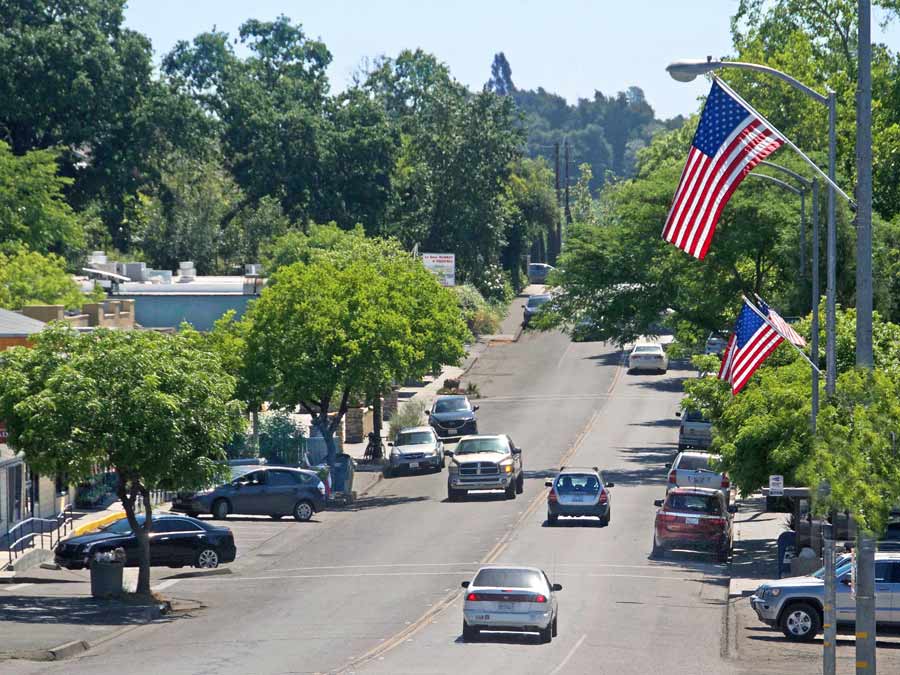 Crs drive down the cute main street lined with American flags in Forestville, Sonoma County