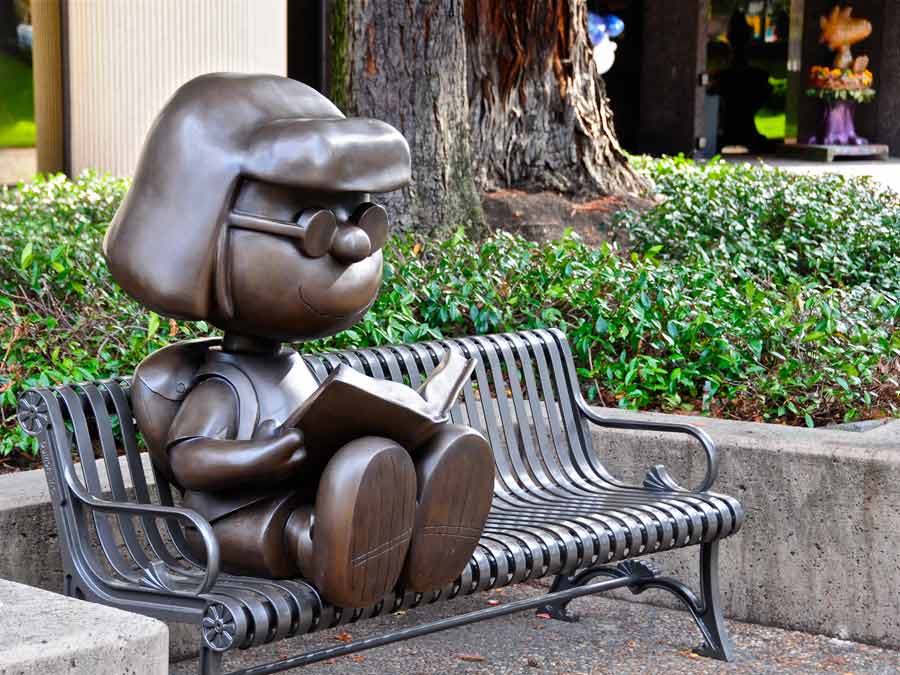 A bronze statue of Marcie sits on a bench under the trees in Santa Rosa, Sonoma County