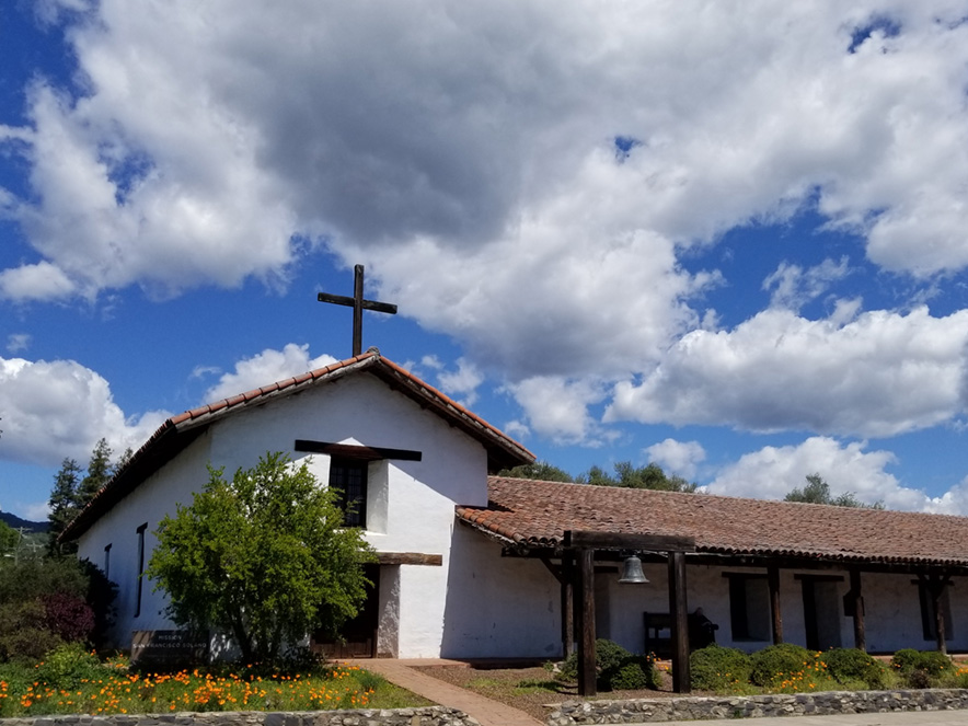 Mission San Francisco Solano against a cloud scattered blue sky in Sonoma County, California