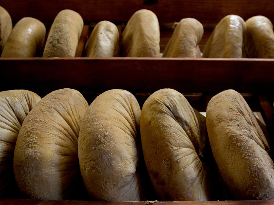 Rounds of cheese aging