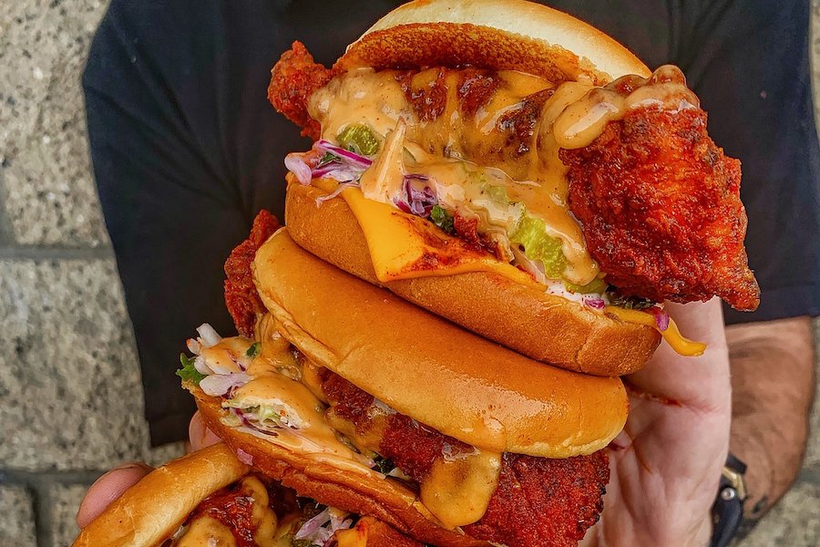 Stack of fried chicken sandwiches from Dave's Hot Chicken