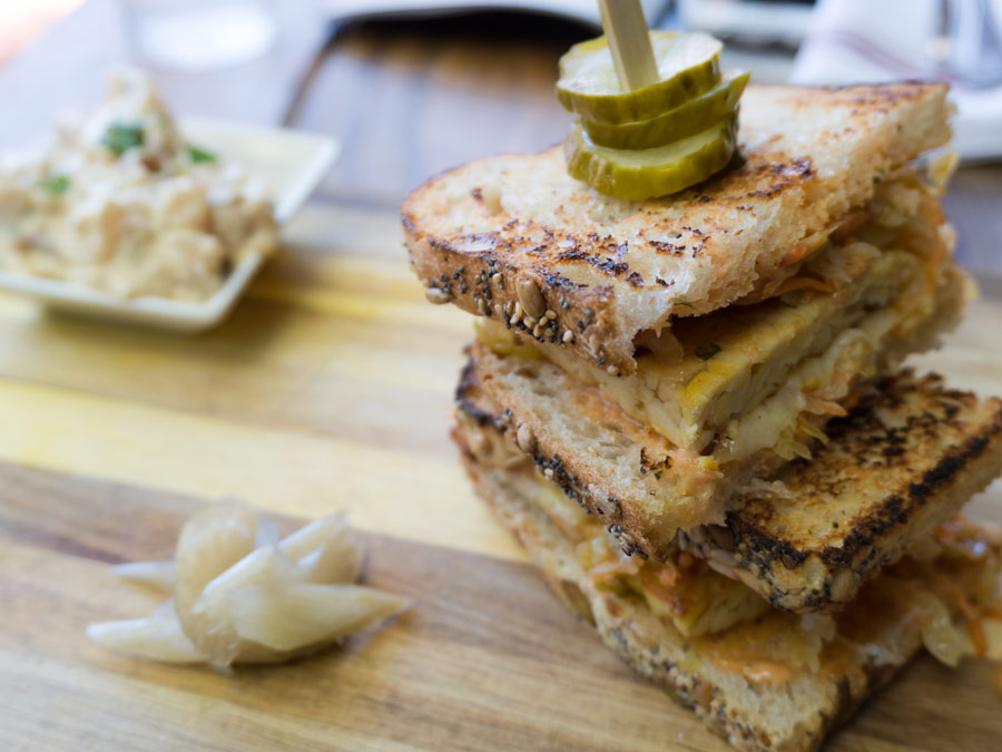 A tempeh sandwich at Backyard in Forestville, Sonoma County, has pickles on top