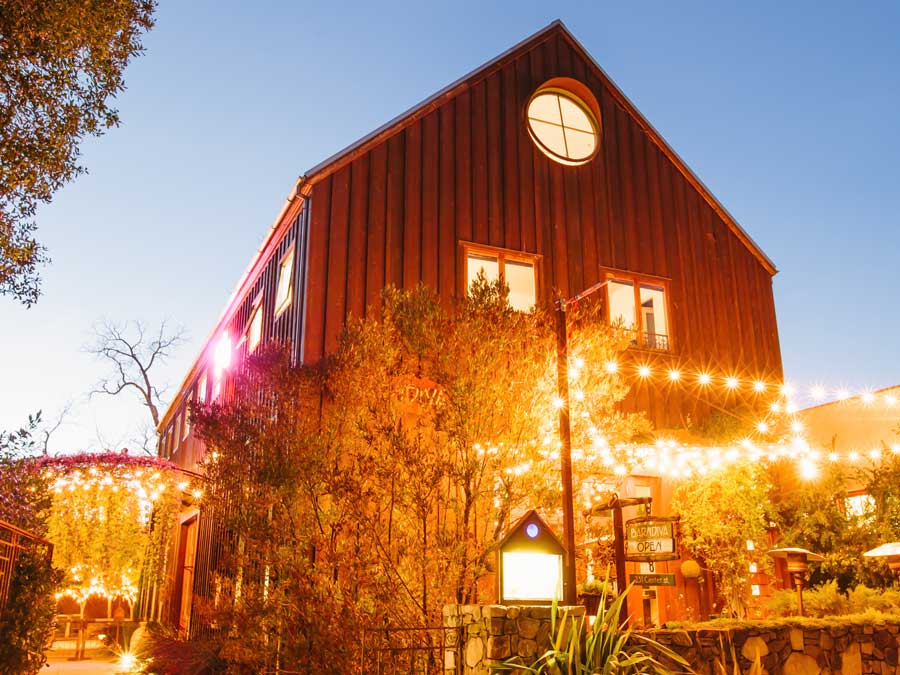 The exterior of the barn is lit up at night