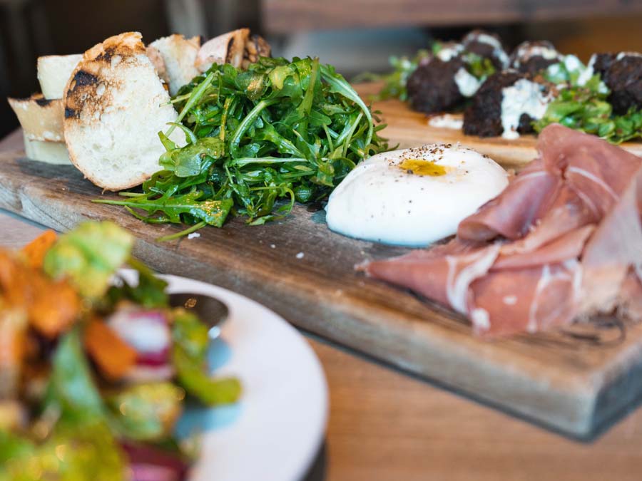 Burrata, proscuitto, and arugula served as an appetizer in Sonoma County