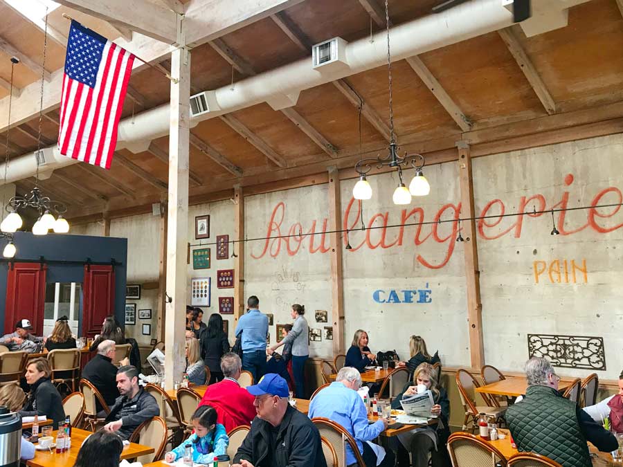 The bakery has Boulangerie painted on the interior wall