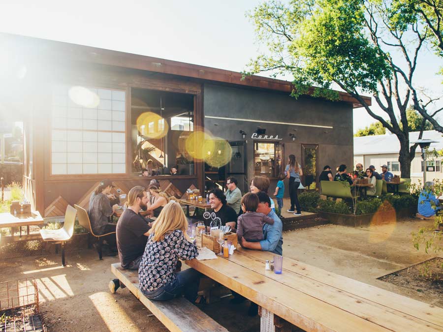 People din at picnic tables outside on a pation in Sonoma County