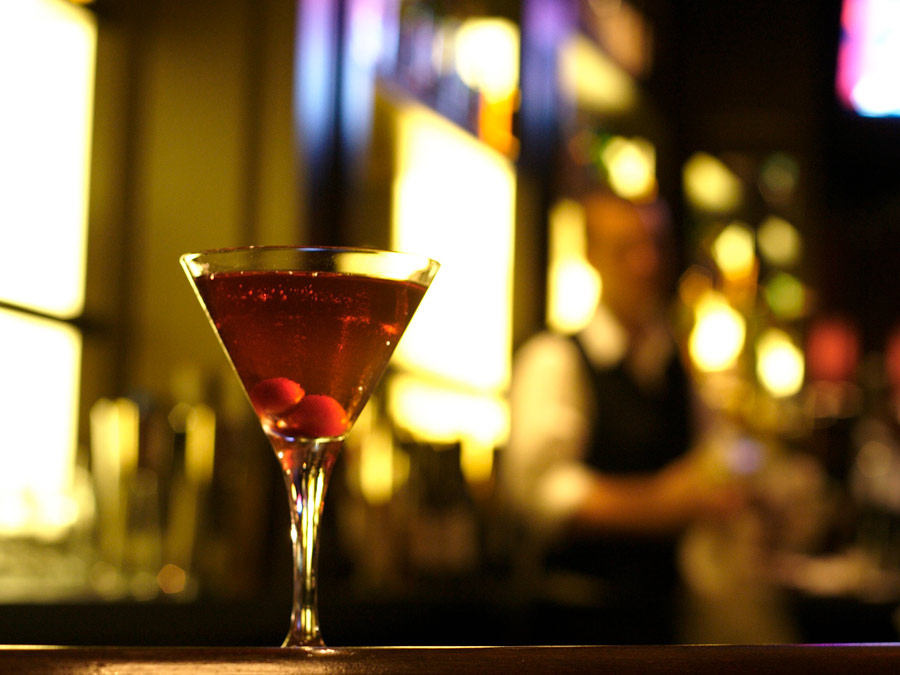 A manhattan with cherries in the bottom of the martini glass