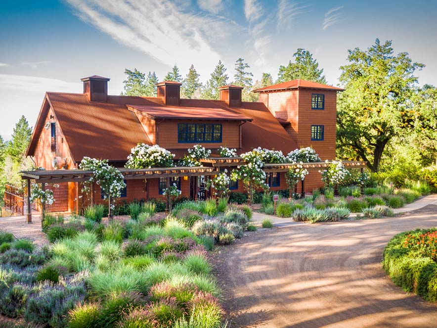 building with gardens outside and on roof with blue sky