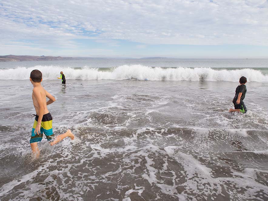 kids playing in water at beach