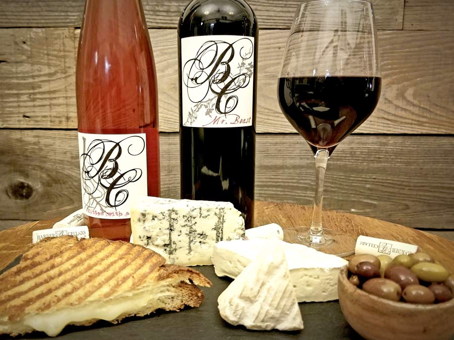 Two bottles of wine paired with cheese