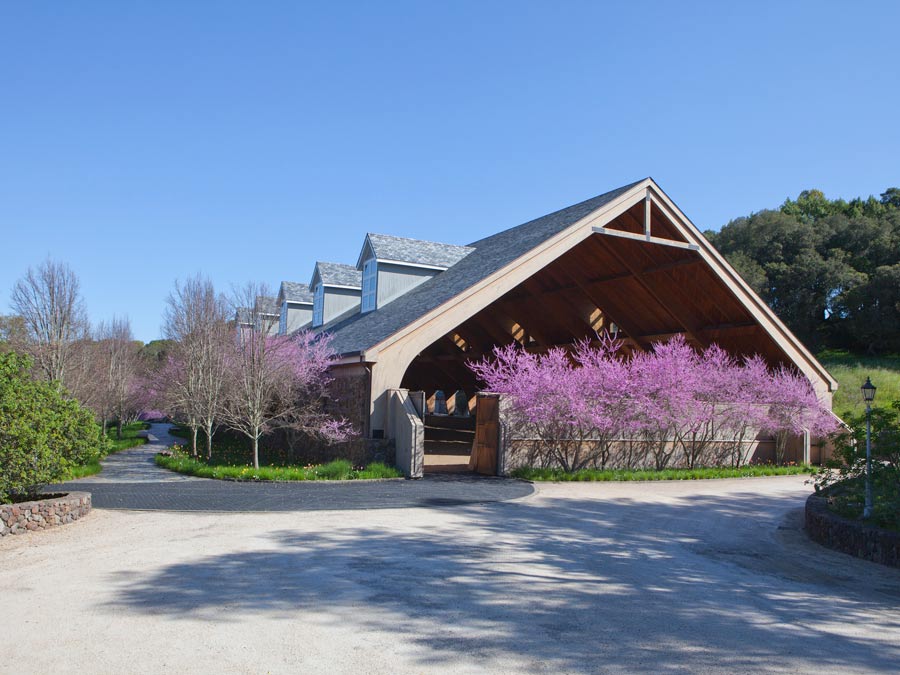 The horse pavilion at Chalk Hill is flanked by blooming trees in Sonoma County