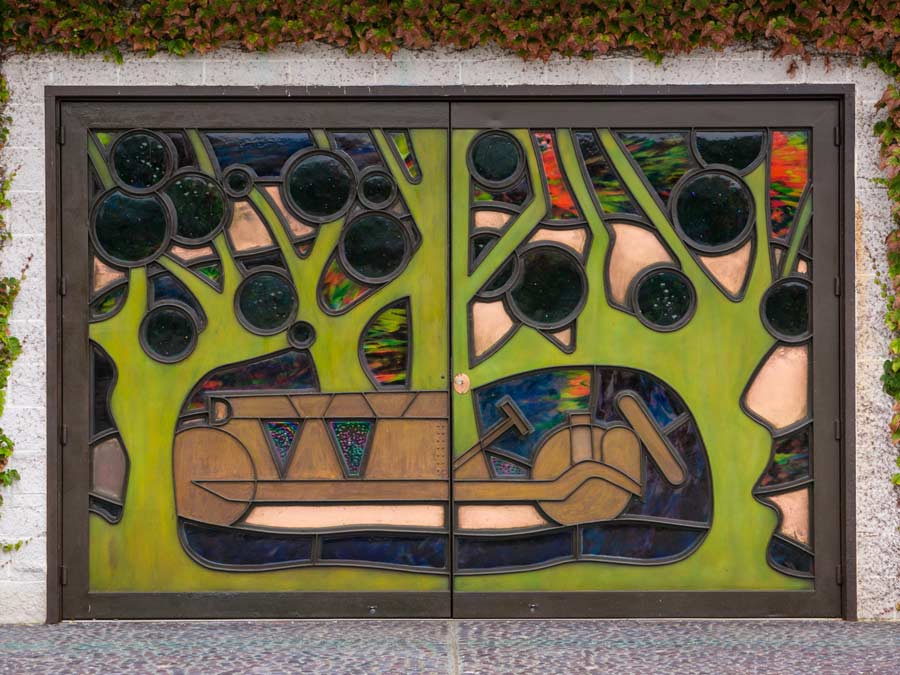 A stained glass image of a race car on the door to the winery