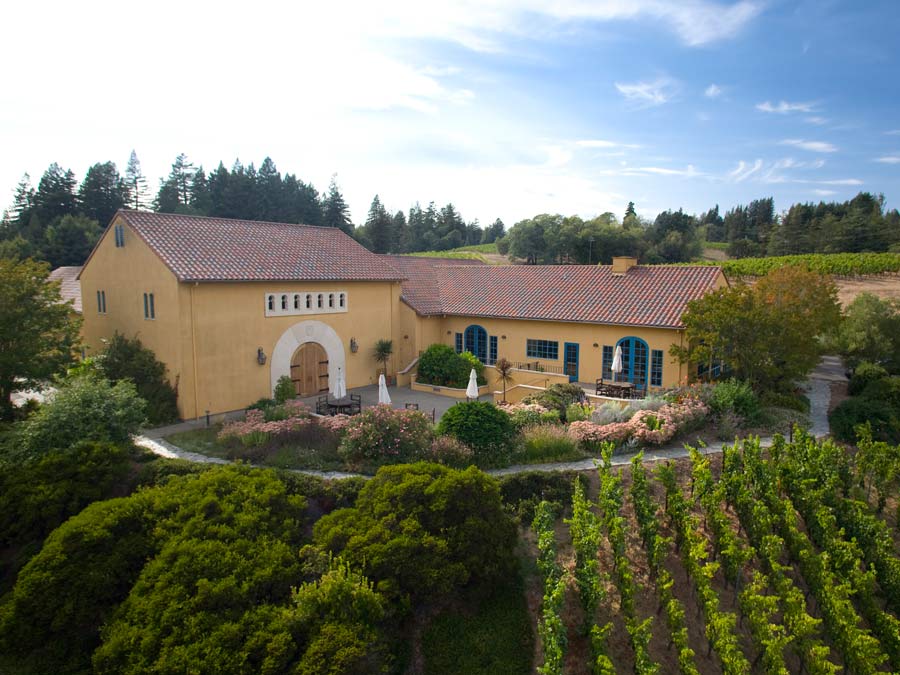 The Spanish styled building is surrounded by vineyards