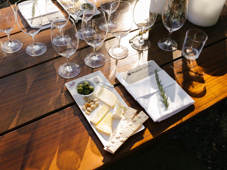 A table set with wine glasses and a cheese pairing