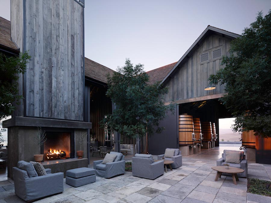 The tasting barn has a rustic seating area outside