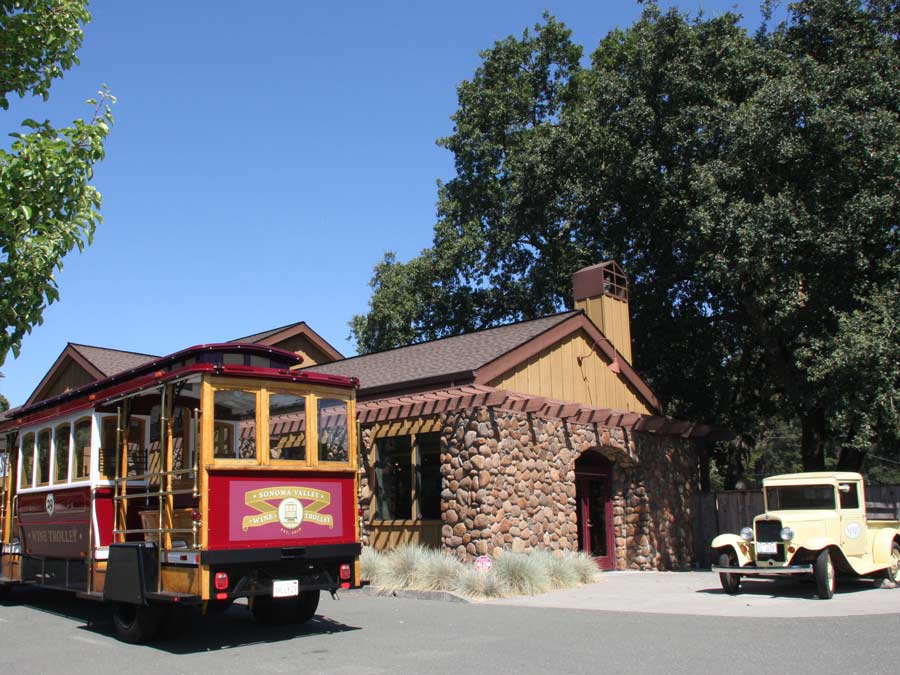 The motorized wine trolley is parked outside of a winery in Sonoma County