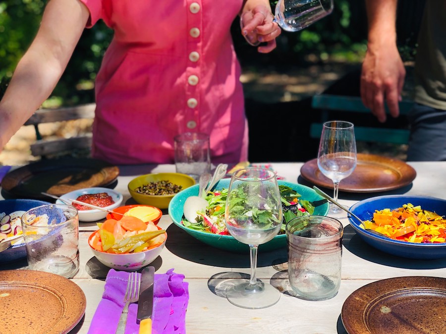 A table laden with colorful dishes and wine glasses at Valley Bar + Bottle in Sonoma