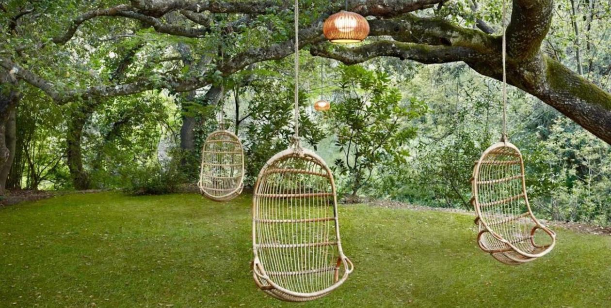 Swing chairs hang from a live oak at Gaige House