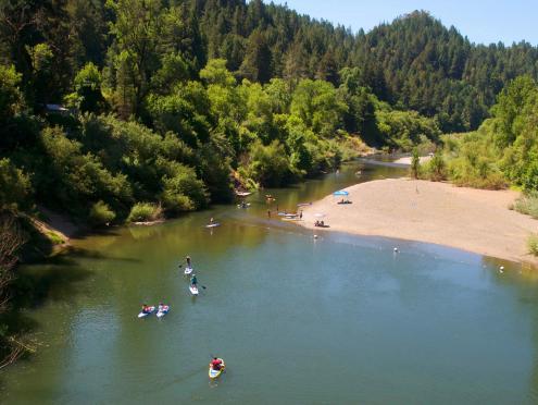 People paddle board in the Russian River in Sonoma County