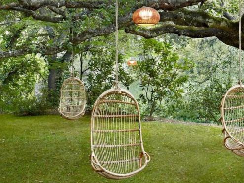 Swing chairs hang from a live oak at Gaige House